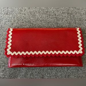 NWOT Loefler Randall red leather wallet with white zig zag detail.